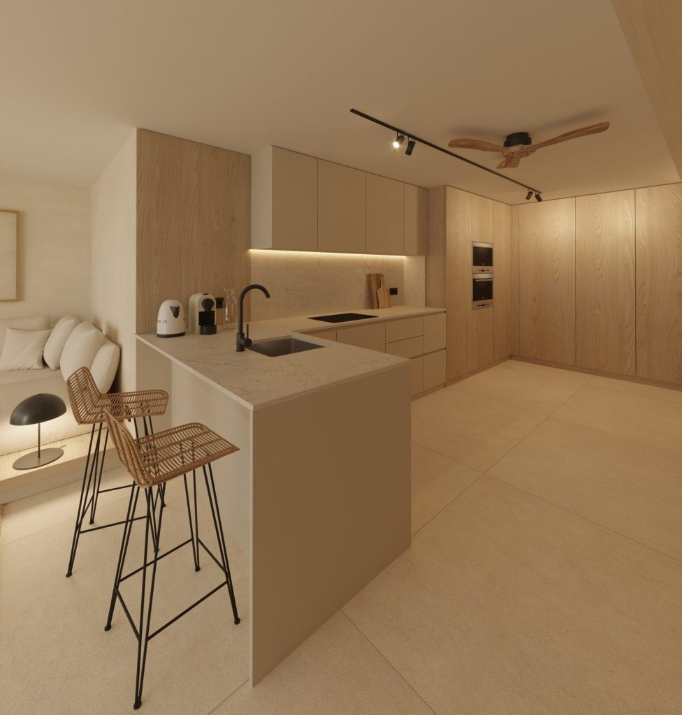 Salón con cocina abierta y mobiliario de madera en apartamento reformado en Sant Pol de Mar